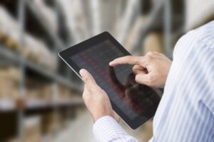 man with tablet showing inventory control in warehouse