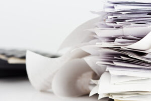 stack of papers due to not using erp software